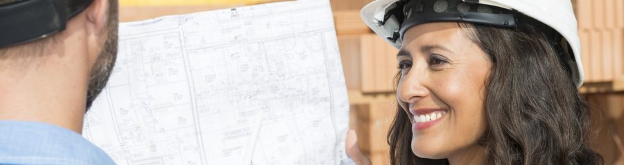 Man with pen pointing at architectural drawing