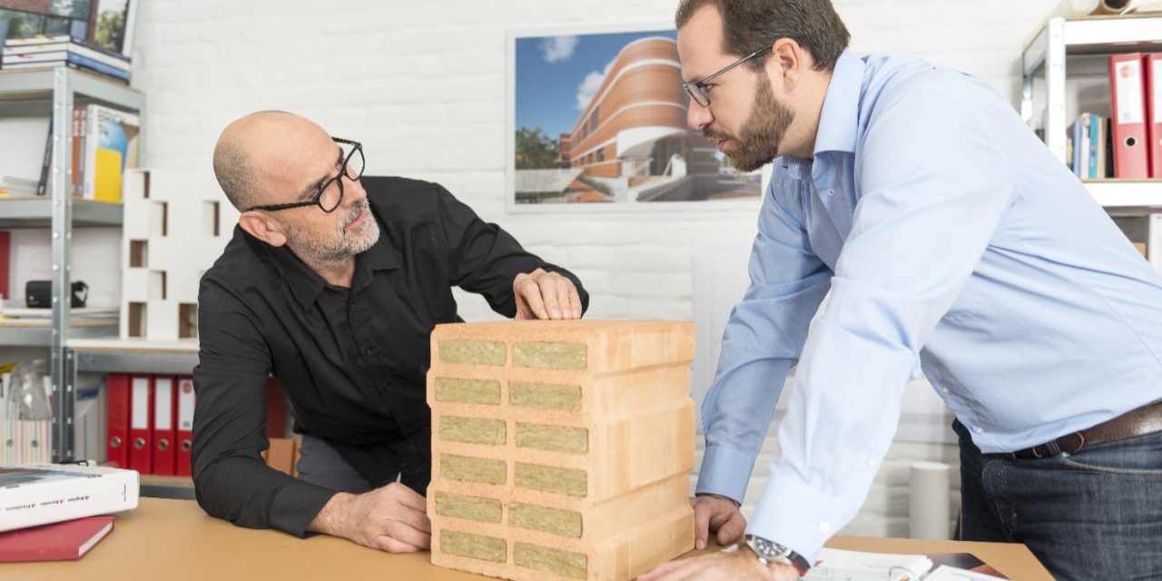 Architect and Wienerberger project manager talking about advantages of a mineral wool infilled clay block at architect's office