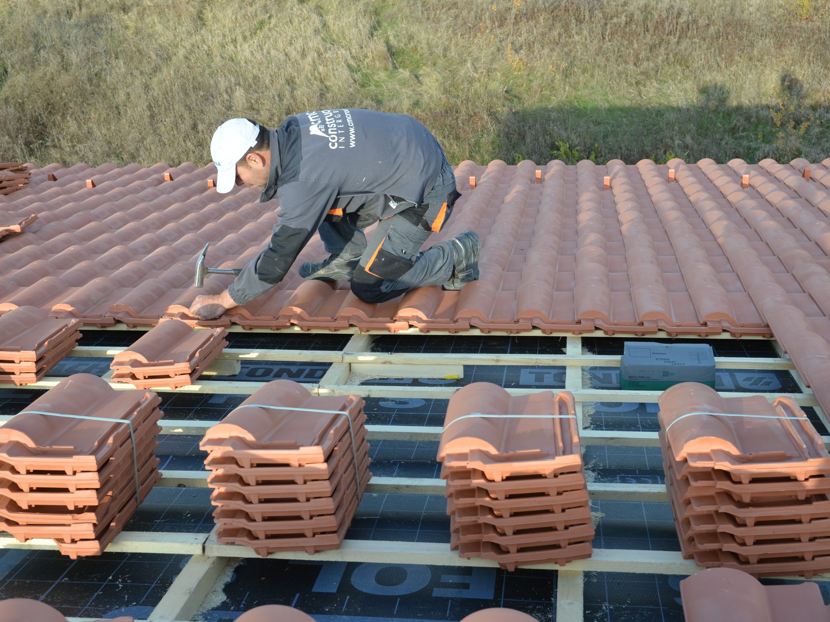 man working on roof, clay tiles, second e4 house