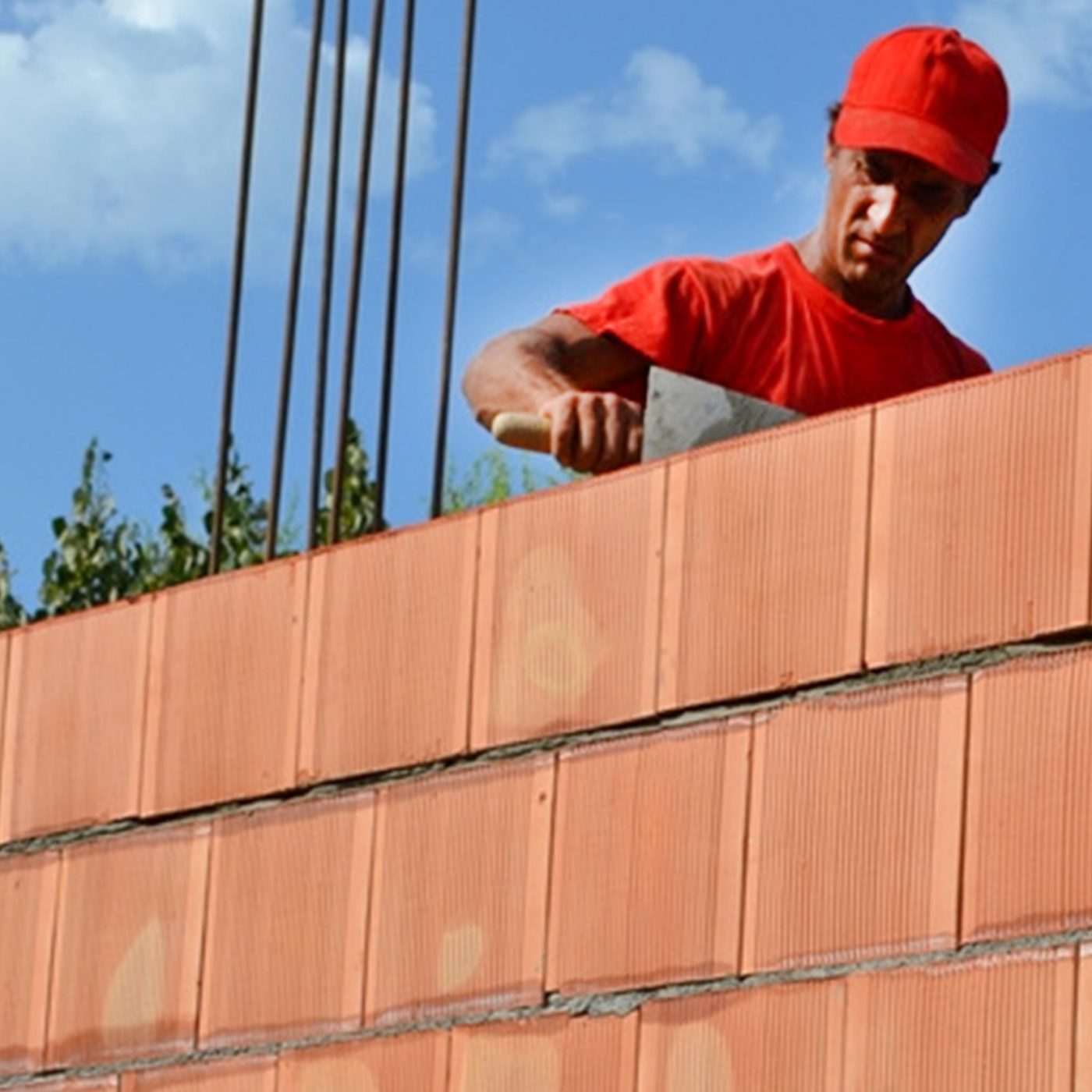 man working with porotherm bricks 